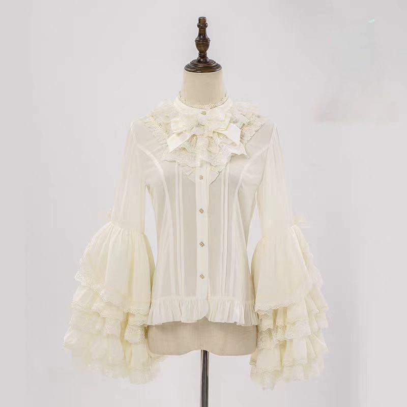 This dreamy Lolita blouse features soft puff sleeves and delicate sheer mesh detailing in blush pink and peach tones. Designed for daily wear, its lightweight fabric offers comfortable layering under JSKs or jumpers. The sweet yet versatile design balances elegance with practicality, perfect for creating charmingly coordinations with a touch of ethereal romance.
