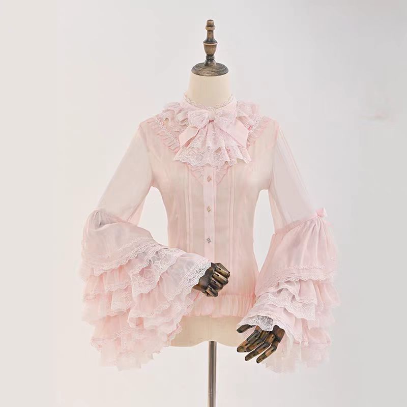 This dreamy Lolita blouse features soft puff sleeves and delicate sheer mesh detailing in blush pink and peach tones. Designed for daily wear, its lightweight fabric offers comfortable layering under JSKs or jumpers. The sweet yet versatile design balances elegance with practicality, perfect for creating charmingly coordinations with a touch of ethereal romance.