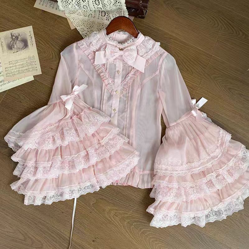 This dreamy Lolita blouse features soft puff sleeves and delicate sheer mesh detailing in blush pink and peach tones. Designed for daily wear, its lightweight fabric offers comfortable layering under JSKs or jumpers. The sweet yet versatile design balances elegance with practicality, perfect for creating charmingly coordinations with a touch of ethereal romance.