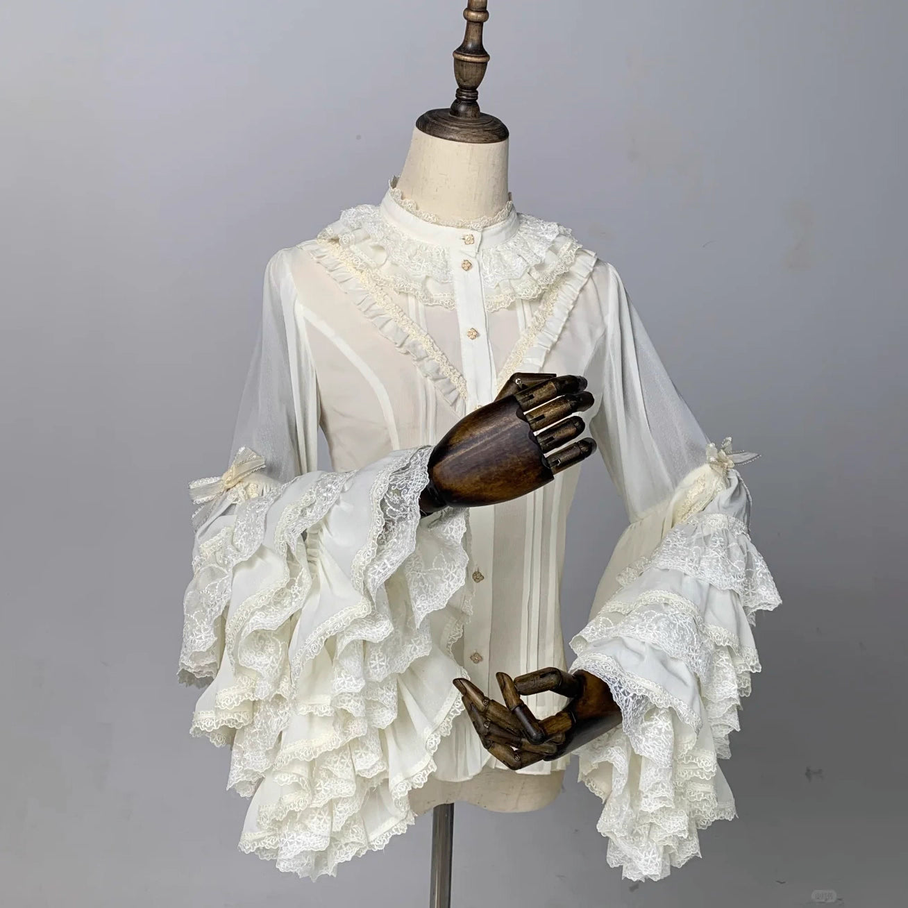 This dreamy Lolita blouse features soft puff sleeves and delicate sheer mesh detailing in blush pink and peach tones. Designed for daily wear, its lightweight fabric offers comfortable layering under JSKs or jumpers. The sweet yet versatile design balances elegance with practicality, perfect for creating charmingly coordinations with a touch of ethereal romance.