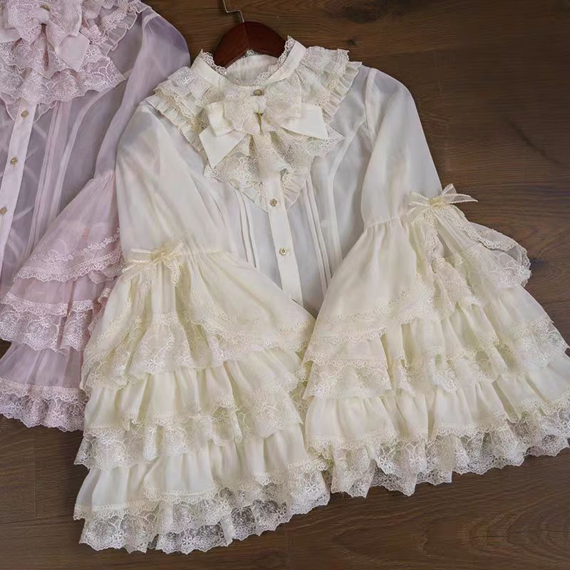 This dreamy Lolita blouse features soft puff sleeves and delicate sheer mesh detailing in blush pink and peach tones. Designed for daily wear, its lightweight fabric offers comfortable layering under JSKs or jumpers. The sweet yet versatile design balances elegance with practicality, perfect for creating charmingly coordinations with a touch of ethereal romance.