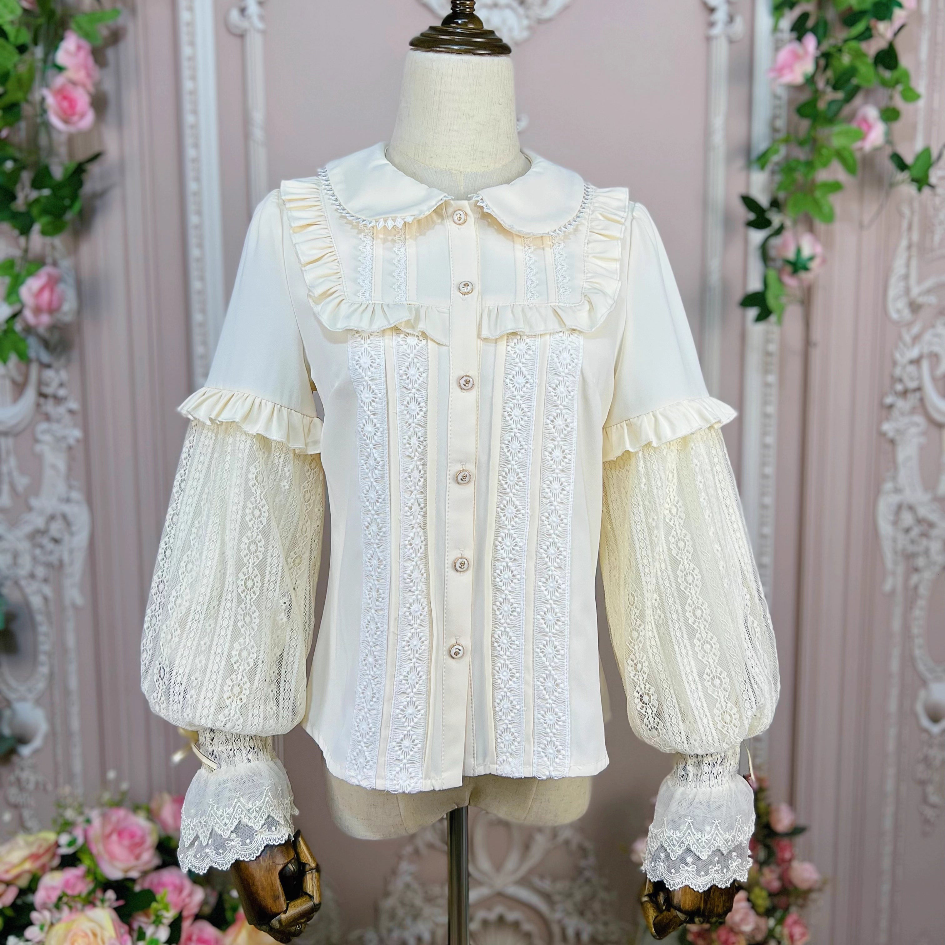 This elegant Lolita blouse combines a classic doll collar with soft bishop sleeves, creating a timeless silhouette. Designed with delicate details and a tailored fit, it offers versatile layering under jumpers or dresses. The refined design balances vintage charm and modern sweetness, perfect for adding romantic sophistication to both classic and sweet Lolita coordinates.