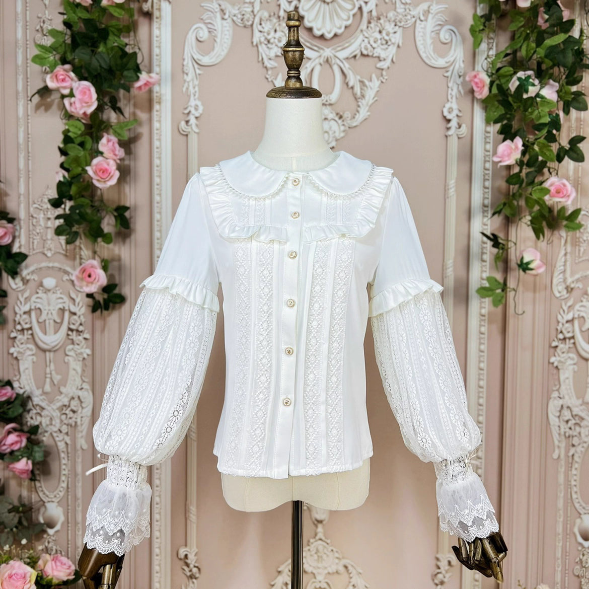 This elegant Lolita blouse combines a classic doll collar with soft bishop sleeves, creating a timeless silhouette. Designed with delicate details and a tailored fit, it offers versatile layering under jumpers or dresses. The refined design balances vintage charm and modern sweetness, perfect for adding romantic sophistication to both classic and sweet Lolita coordinates.
