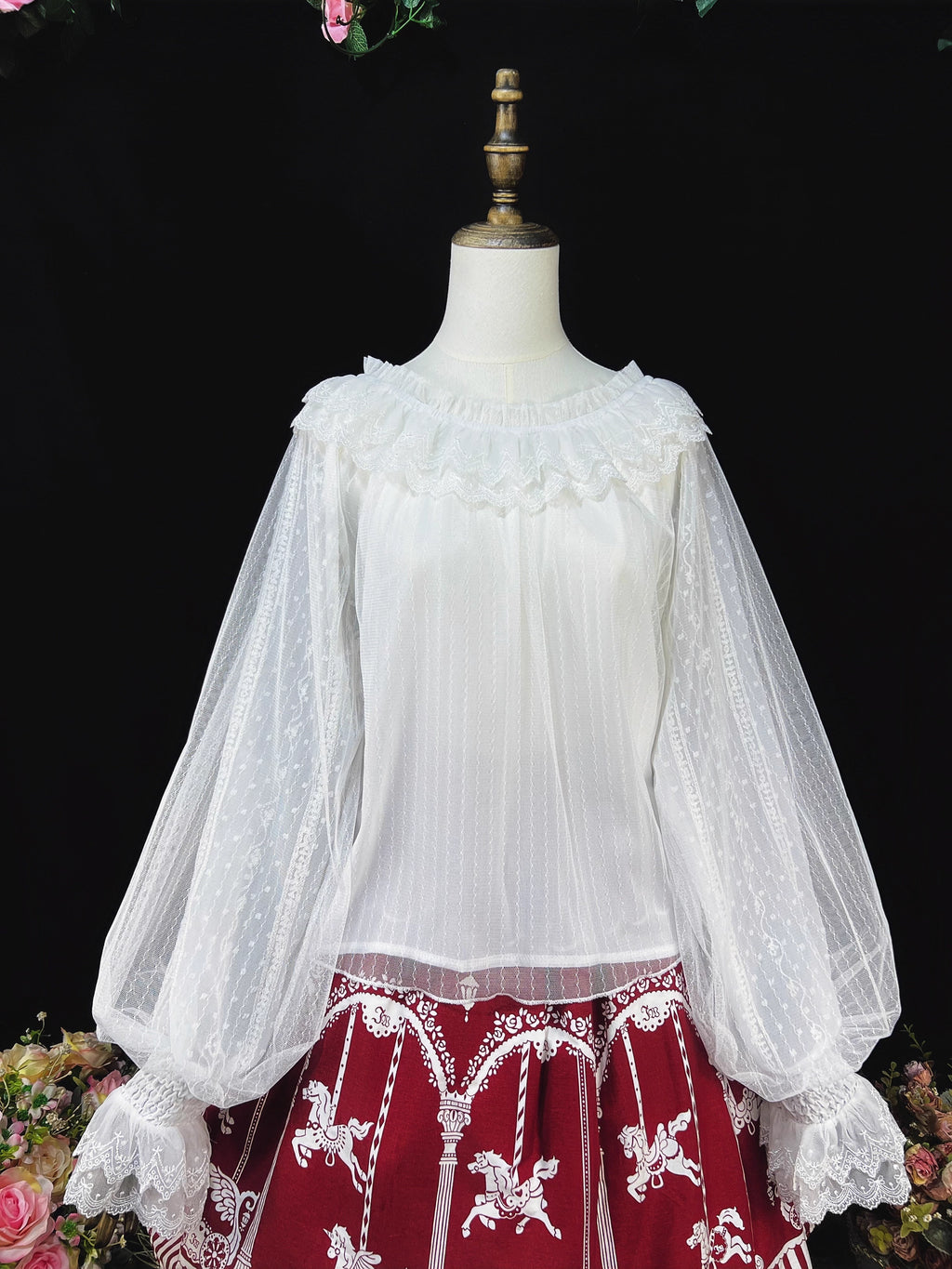 This elegant blouse combines sheer mesh fabric with dramatic leg-of-mutton sleeves and a comfortable elastic neckline. Perfect for spring and autumn layering, its lightweight texture adds depth to coordinates while maintaining a romantic silhouette. The design balances vintage inspiration with modern wearability, creating a versatile piece that transitions seamlessly from sweet to Gothic styles.
