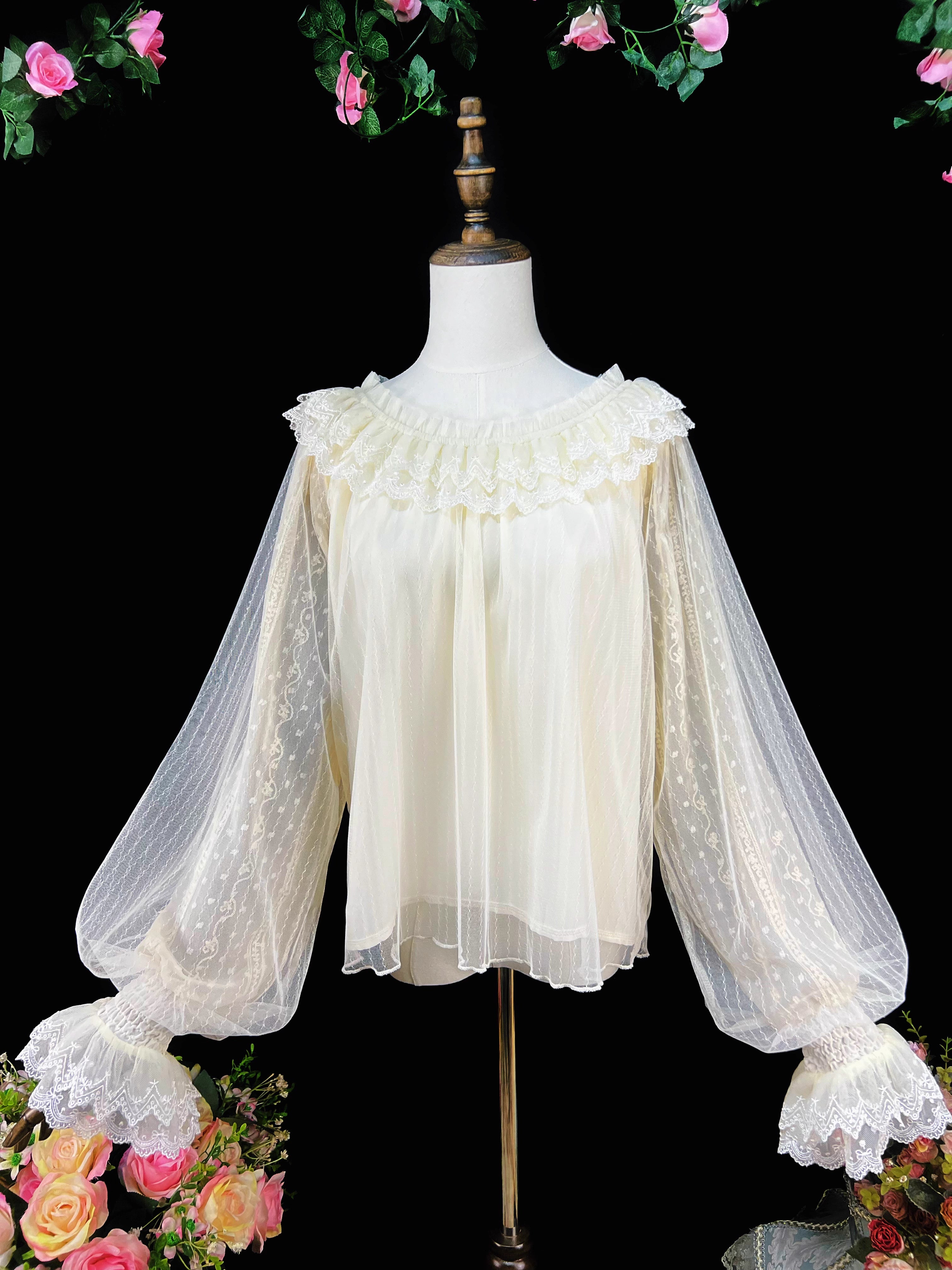 This elegant blouse combines sheer mesh fabric with dramatic leg-of-mutton sleeves and a comfortable elastic neckline. Perfect for spring and autumn layering, its lightweight texture adds depth to coordinates while maintaining a romantic silhouette. The design balances vintage inspiration with modern wearability, creating a versatile piece that transitions seamlessly from sweet to Gothic styles.