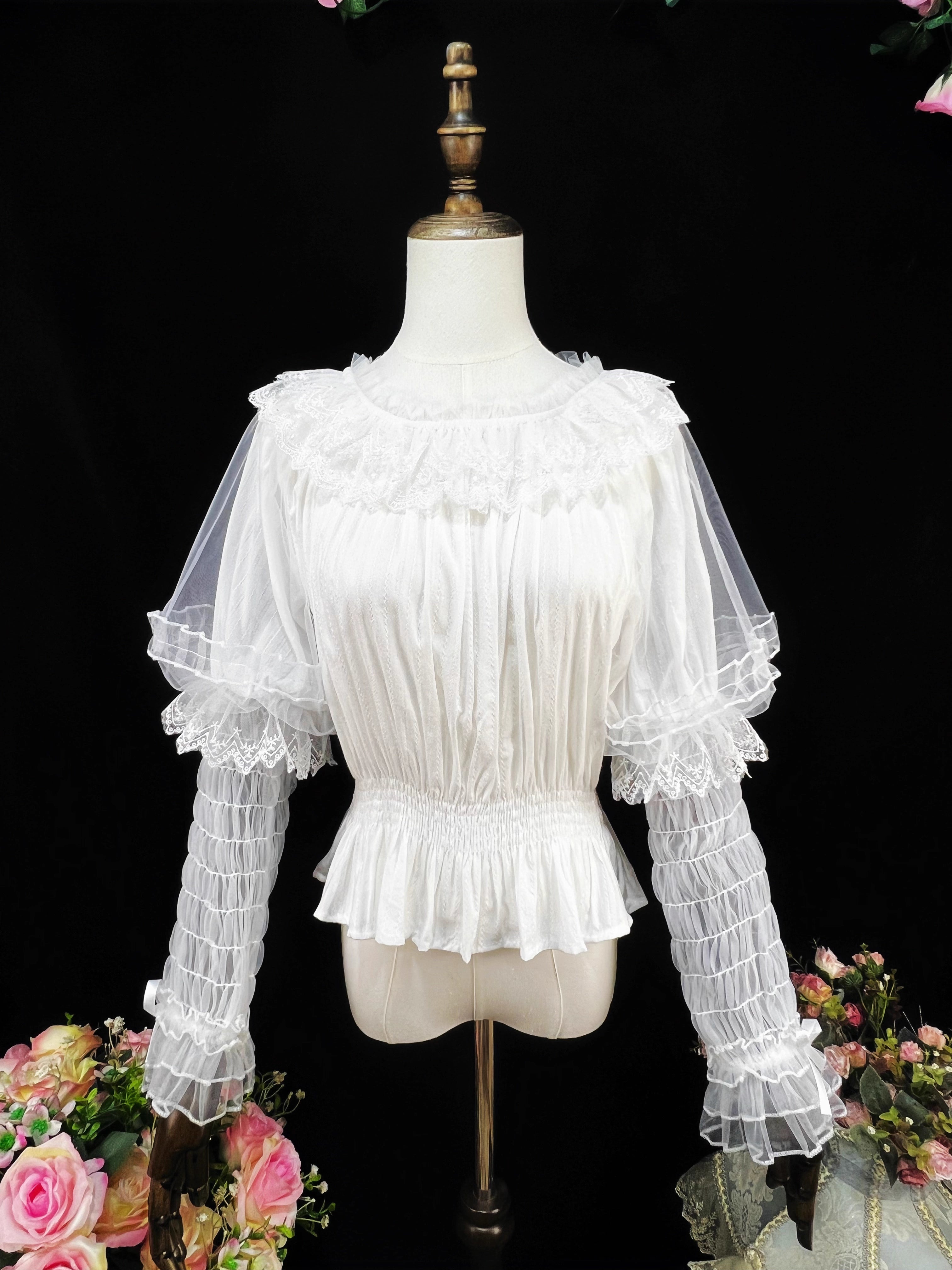 This retro-inspired blouse blends soft cotton with delicate mesh panels for textured elegance. The round neckline and relaxed fit offer timeless comfort, while subtle vintage details create a versatile layering piece. Perfect under jumpers or dresses, it effortlessly bridges classic and sweet Lolita styles with understated sophistication.