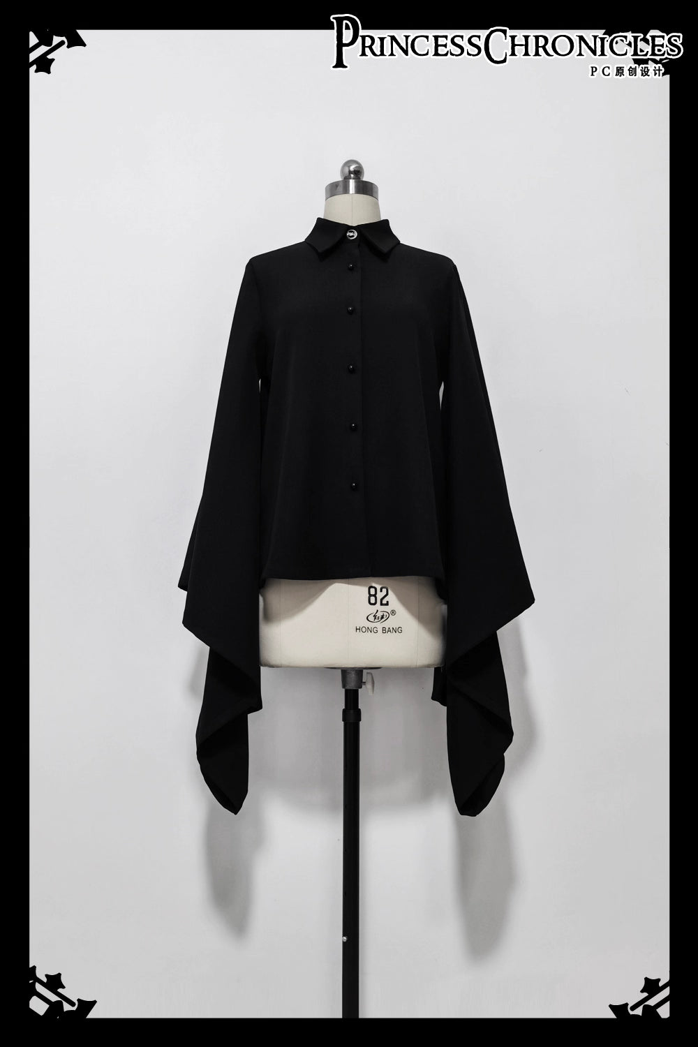 Inspired by Tang dynasty aesthetics, this top reimagines classical elegance with dramatic pointed collars and flowing wide sleeves. The luxurious black fabric serves as a canvas for subtle embroidered pomegranate motifs—symbolizing prosperity and unity. Lightweight yet structured, it layers seamlessly under modern outerwear, blending historical narrative with wearable artistry for a timeless statement of cultural fusion.