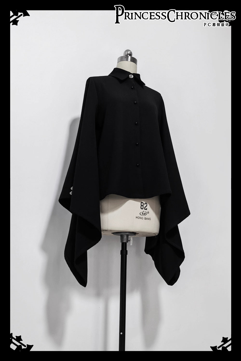 Inspired by Tang dynasty aesthetics, this top reimagines classical elegance with dramatic pointed collars and flowing wide sleeves. The luxurious black fabric serves as a canvas for subtle embroidered pomegranate motifs—symbolizing prosperity and unity. Lightweight yet structured, it layers seamlessly under modern outerwear, blending historical narrative with wearable artistry for a timeless statement of cultural fusion.