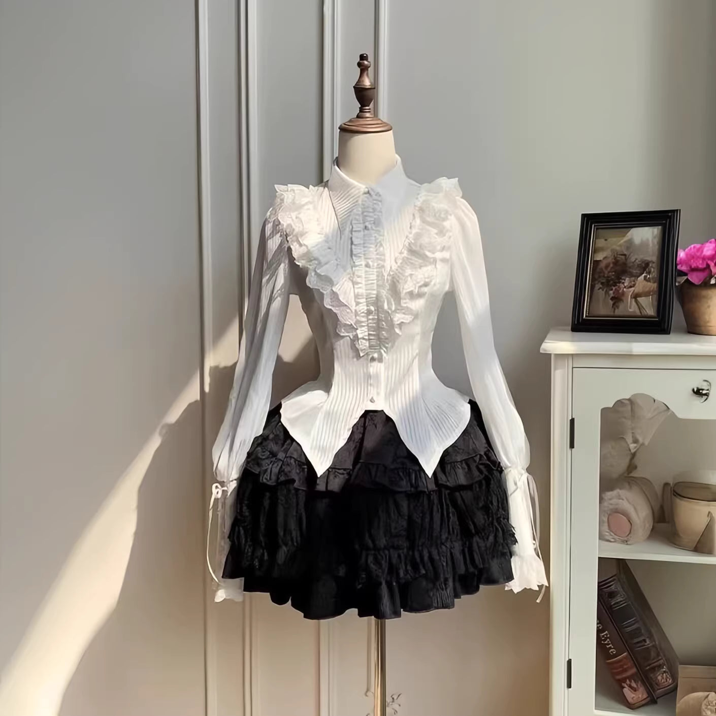 Design Concept:

This Gothic Lolita blouse is crafted with a thin and lightweight fabric, featuring vintage-inspired lantern sleeves and a refined prince-style silhouette. The black and white color options enhance its versatility, allowing it to pair elegantly with a variety of Lolita skirts or outerwear. Its delicate construction balances both comfort and sophistication, making it suitable for daily wear, themed gatherings, or cosplay occasions.