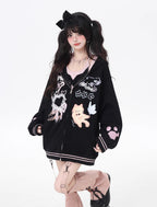 This adorable hoodie combines sweet lace accents with a playful kitten print in classic black and white. The relaxed fit and soft fabric offer everyday comfort, while the checkered pattern and lace details add a touch of romantic charm. Perfect for expressing a love for all things cute and cozy this autumn.