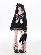 This adorable hoodie combines sweet lace accents with a playful kitten print in classic black and white. The relaxed fit and soft fabric offer everyday comfort, while the checkered pattern and lace details add a touch of romantic charm. Perfect for expressing a love for all things cute and cozy this autumn.