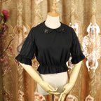 Design Concept:
This Lolita blouse features a delicate doll collar and a cropped, short silhouette, designed as a versatile inner layer for JSKs and other Lolita outfits. The soft chiffon fabric adds a gentle drape and elegant touch, making it suitable for layering or wearing on its own. Available in White and Black, it complements both sweet and Gothic Lolita styles.
