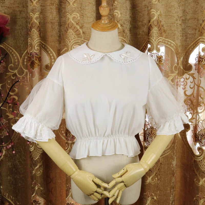 Design Concept:
This Lolita blouse features a delicate doll collar and a cropped, short silhouette, designed as a versatile inner layer for JSKs and other Lolita outfits. The soft chiffon fabric adds a gentle drape and elegant touch, making it suitable for layering or wearing on its own. Available in White and Black, it complements both sweet and Gothic Lolita styles.