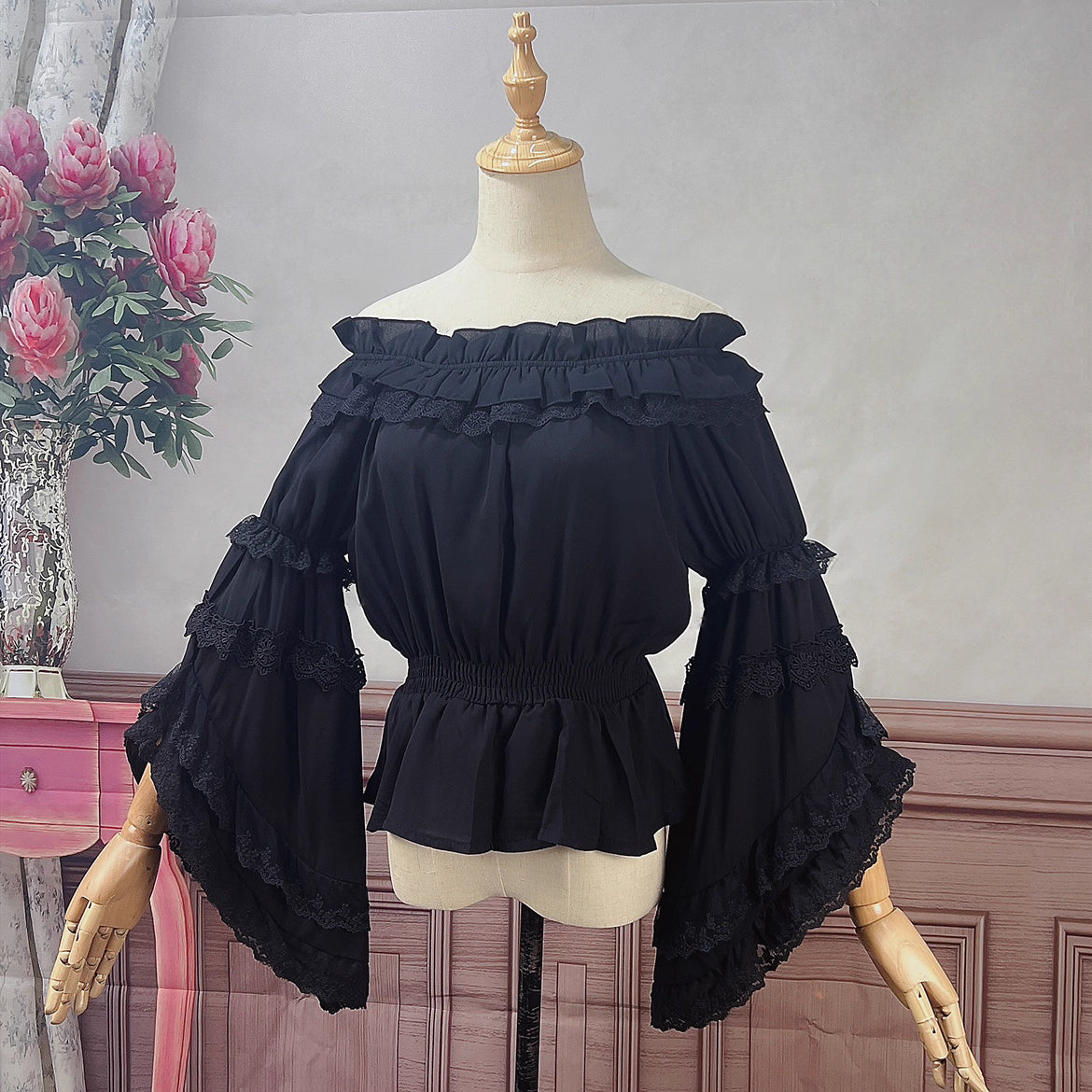 Design Concept:
This Lolita chiffon blouse brings a graceful and romantic aesthetic with its elastic neckline and off-shoulder design. The flowing silhouette enhances the charm of Lolita coordinates, while the gorgeous detailing adds a touch of elegance. Available in White and Black, it offers both a fresh, pure option and a dramatic, Gothic-inspired alternative.