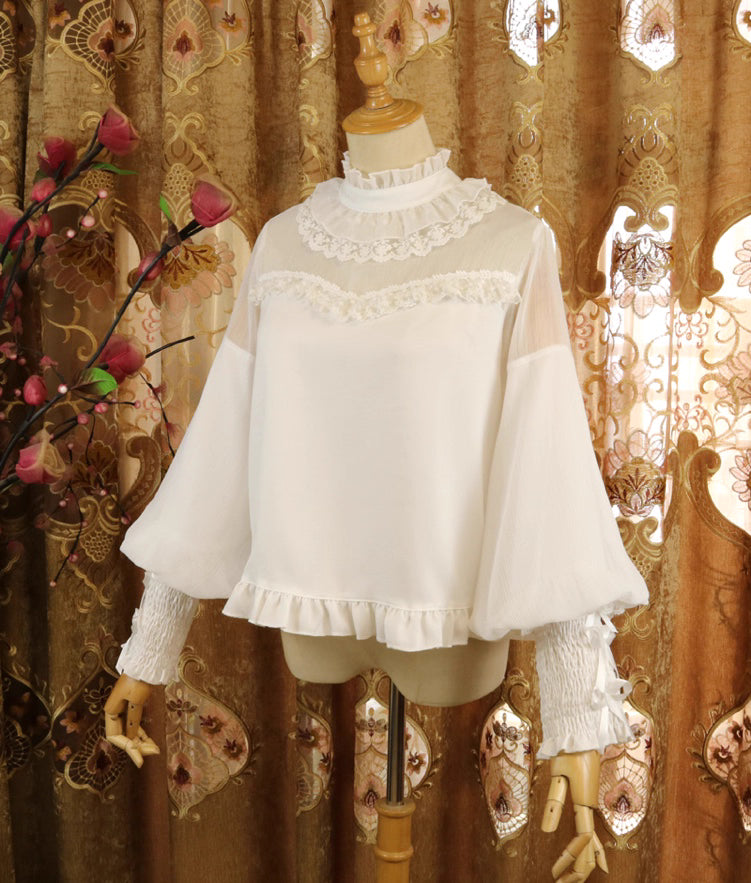 Design Concept:
This Lolita blouse combines classic elegance with a romantic touch, featuring soft chiffon fabric, graceful leg-of-mutton sleeves, and a refined stand collar. Available in Pure Ivory, Gold-Thread Ivory, and Pure Black, it brings versatile charm to both subtle and dramatic Lolita coordinates. The flowing silhouette and detailed construction make it perfect for layering under dresses or wearing as a statement piece on its own.