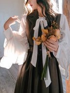 Inspired by the opulent elegance of the French court, this blouse is a masterpiece of romantic detail. Crafted in a subtly shimmering fabric, it features dramatic puff sleeves and delicate ruffled accents. The adjustable tie-front closure allows for a customizable fit, blending historical grandeur with modern wearability. This piece is designed for those who wish to infuse their everyday style with a touch of aristocratic fantasy and timeless grace.