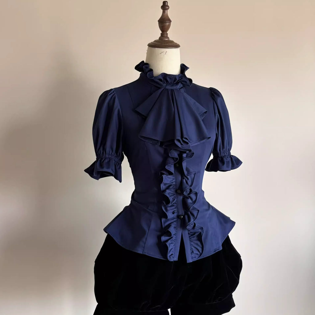 This striking Klein blue Lolita shirt redefines Gothic elegance with its bold fusion of medieval prince aesthetics and contemporary dark fashion. The short sleeve design features intricate ruffles and Victorian-inspired tailoring, creating a dramatic yet wearable statement piece. The vibrant Klein blue hue contrasts brilliantly with classic Gothic elements, offering a modern twist on aristocratic style. Perfect for layering or standalone wear, it embodies luxurious rebellion—ideal for those seeking to merge