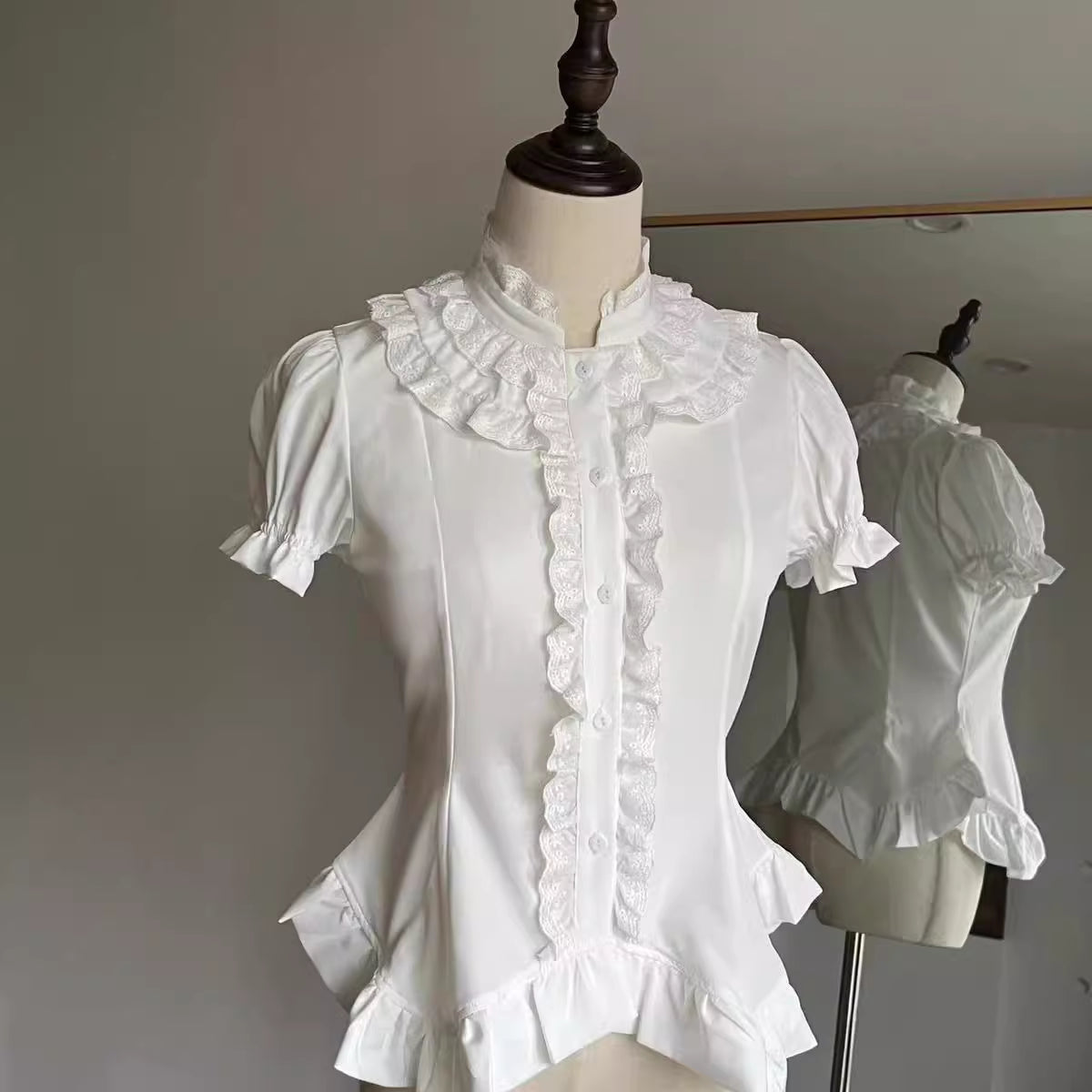 Design Concept:
This Gothic Lolita blouse features a lightweight, soft fabric with vintage-style lantern sleeves and a slim, prince-inspired silhouette. Offered in both black and white, it can be effortlessly styled with various Lolita skirts or layered under outerwear. Combining elegance with comfort, it’s ideal for everyday wear, themed tea parties, or cosplay events.