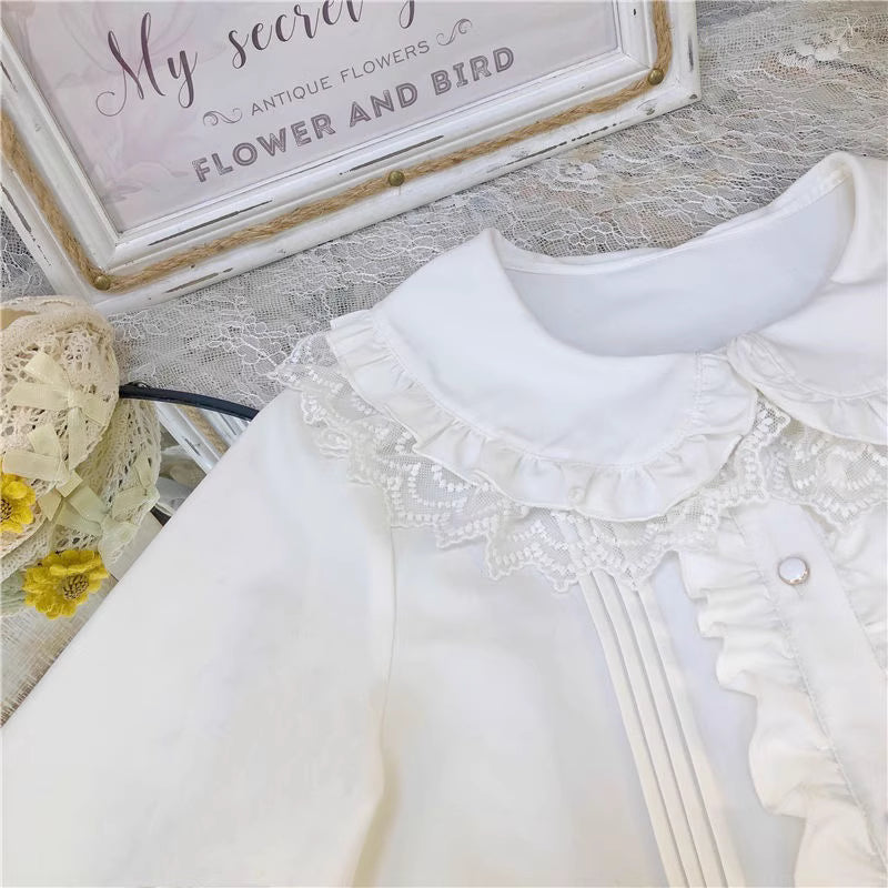 This charming blouse blends JK style with sweet Lolita details for a truly adorable look. The classic Peter Pan collar and delicate lace trim offer timeless appeal, while the playful bubble sleeves add a touch of whimsy. Perfect for layering under jumperskirts or wearing on its own, this versatile piece is crafted from soft, comfortable fabric. Its cute design makes it ideal for creating innocent and romantic coordinates that capture the essence of youthful elegance.