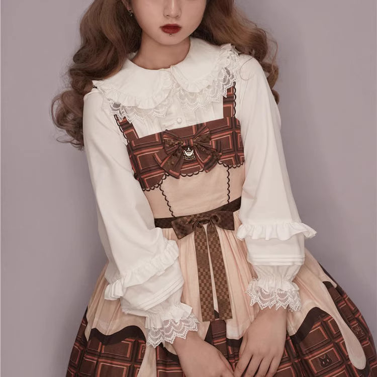 This charming blouse blends JK style with sweet Lolita details for a truly adorable look. The classic Peter Pan collar and delicate lace trim offer timeless appeal, while the playful bubble sleeves add a touch of whimsy. Perfect for layering under jumperskirts or wearing on its own, this versatile piece is crafted from soft, comfortable fabric. Its cute design makes it ideal for creating innocent and romantic coordinates that capture the essence of youthful elegance.