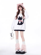 Designed for cozy moments and holiday charm, this ultra-soft ribbed sweater features a delicate kitten-inspired bow detail and a relaxed fit that feels like a warm hug. The classic white and red color blend brings a festive yet gentle vibe, perfect for layering or wearing solo. Whether curled up by the fire or celebrating with friends, this piece wraps you in comfort and quiet elegance—just like a content little cat.