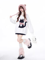 Designed for cozy moments and holiday charm, this ultra-soft ribbed sweater features a delicate kitten-inspired bow detail and a relaxed fit that feels like a warm hug. The classic white and red color blend brings a festive yet gentle vibe, perfect for layering or wearing solo. Whether curled up by the fire or celebrating with friends, this piece wraps you in comfort and quiet elegance—just like a content little cat.
