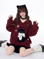 Designed for cozy moments and holiday charm, this ultra-soft ribbed sweater features a delicate kitten-inspired bow detail and a relaxed fit that feels like a warm hug. The classic white and red color blend brings a festive yet gentle vibe, perfect for layering or wearing solo. Whether curled up by the fire or celebrating with friends, this piece wraps you in comfort and quiet elegance—just like a content little cat.