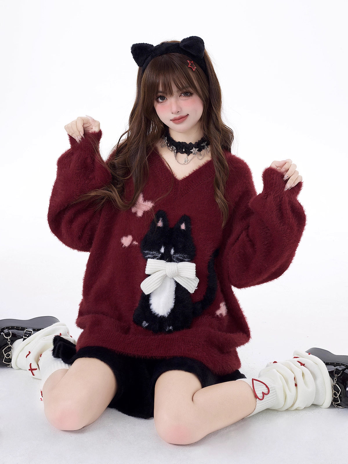 Designed for cozy moments and holiday charm, this ultra-soft ribbed sweater features a delicate kitten-inspired bow detail and a relaxed fit that feels like a warm hug. The classic white and red color blend brings a festive yet gentle vibe, perfect for layering or wearing solo. Whether curled up by the fire or celebrating with friends, this piece wraps you in comfort and quiet elegance—just like a content little cat.