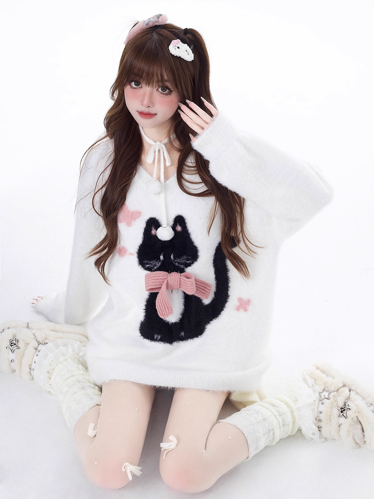 Designed for cozy moments and holiday charm, this ultra-soft ribbed sweater features a delicate kitten-inspired bow detail and a relaxed fit that feels like a warm hug. The classic white and red color blend brings a festive yet gentle vibe, perfect for layering or wearing solo. Whether curled up by the fire or celebrating with friends, this piece wraps you in comfort and quiet elegance—just like a content little cat.