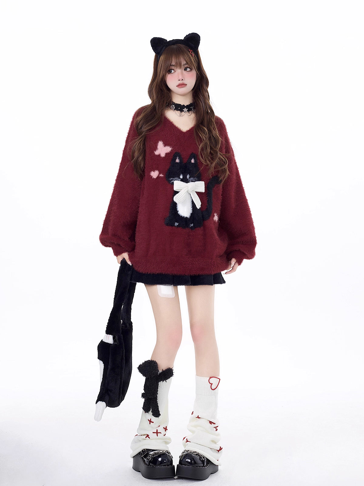 Designed for cozy moments and holiday charm, this ultra-soft ribbed sweater features a delicate kitten-inspired bow detail and a relaxed fit that feels like a warm hug. The classic white and red color blend brings a festive yet gentle vibe, perfect for layering or wearing solo. Whether curled up by the fire or celebrating with friends, this piece wraps you in comfort and quiet elegance—just like a content little cat.