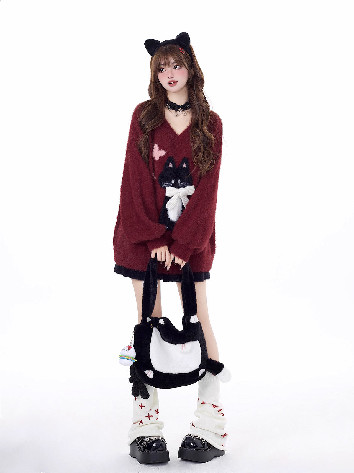 Designed for cozy moments and holiday charm, this ultra-soft ribbed sweater features a delicate kitten-inspired bow detail and a relaxed fit that feels like a warm hug. The classic white and red color blend brings a festive yet gentle vibe, perfect for layering or wearing solo. Whether curled up by the fire or celebrating with friends, this piece wraps you in comfort and quiet elegance—just like a content little cat.