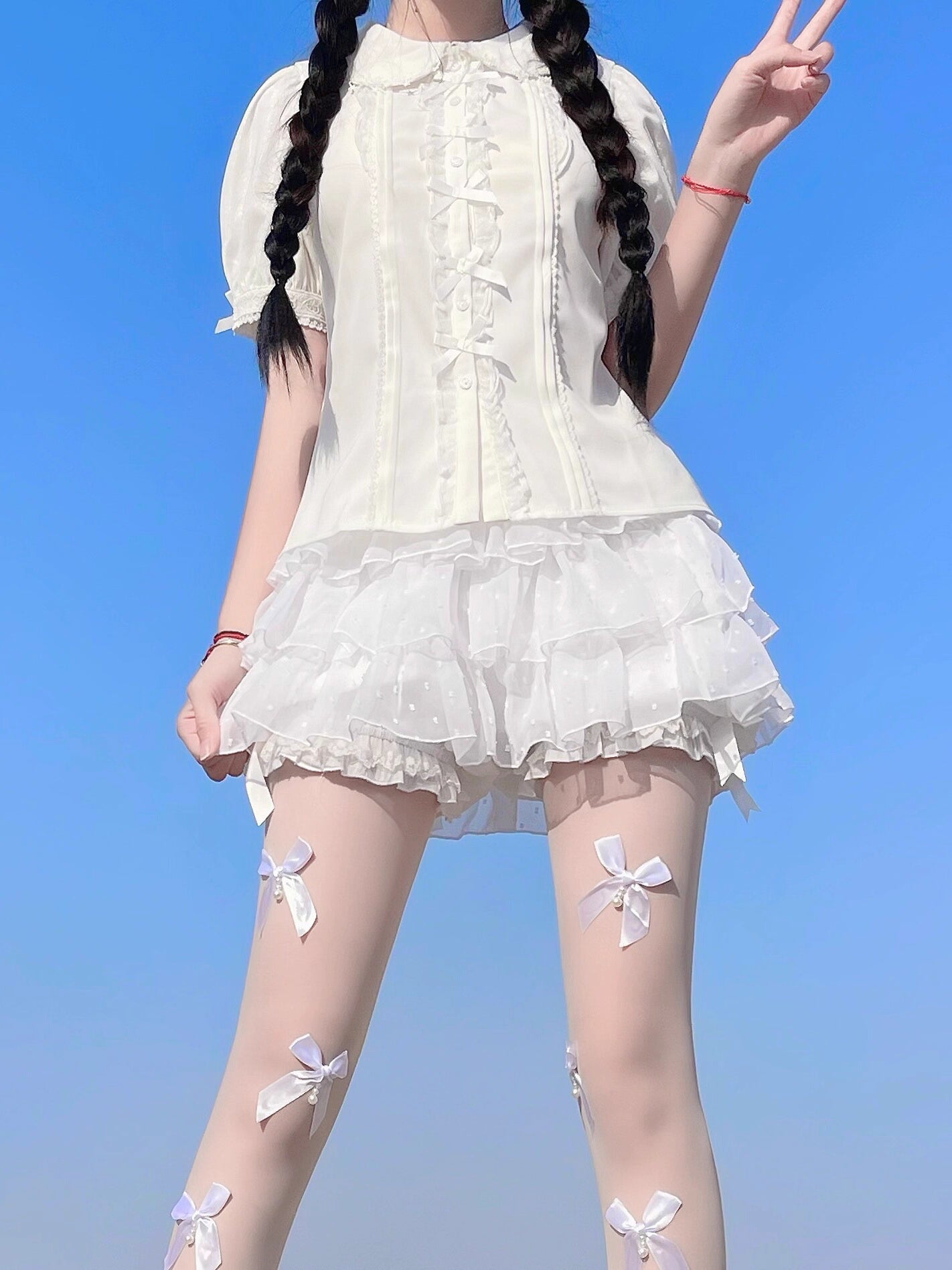 Inspired by moonlit summer nights, this delicate blouse features a classic Peter Pan collar and soft short sleeves. Crafted in pure white, its lightweight fabric and sweet design offer effortless versatility for daily wear. The subtle elegance captures a dreamy, youthful charm, perfect for pairing with summer skirts or jumpers. This piece embodies romantic simplicity, blending timeless Lolita aesthetics with modern comfort for enchanting warm-weather coordinations.