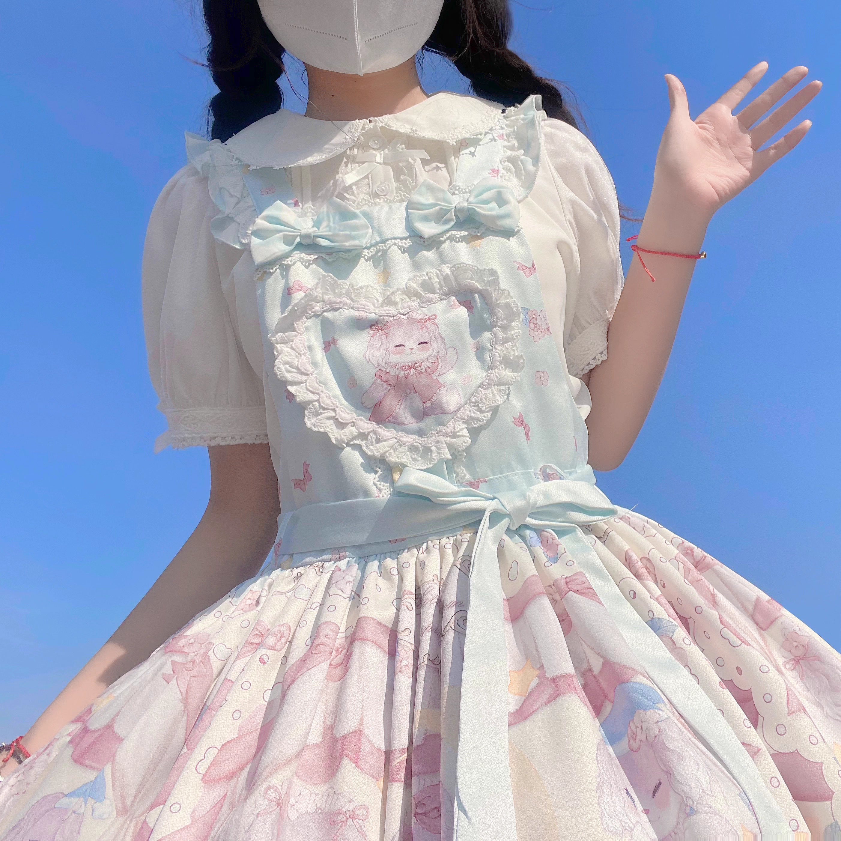 Inspired by moonlit summer nights, this delicate blouse features a classic Peter Pan collar and soft short sleeves. Crafted in pure white, its lightweight fabric and sweet design offer effortless versatility for daily wear. The subtle elegance captures a dreamy, youthful charm, perfect for pairing with summer skirts or jumpers. This piece embodies romantic simplicity, blending timeless Lolita aesthetics with modern comfort for enchanting warm-weather coordinations.