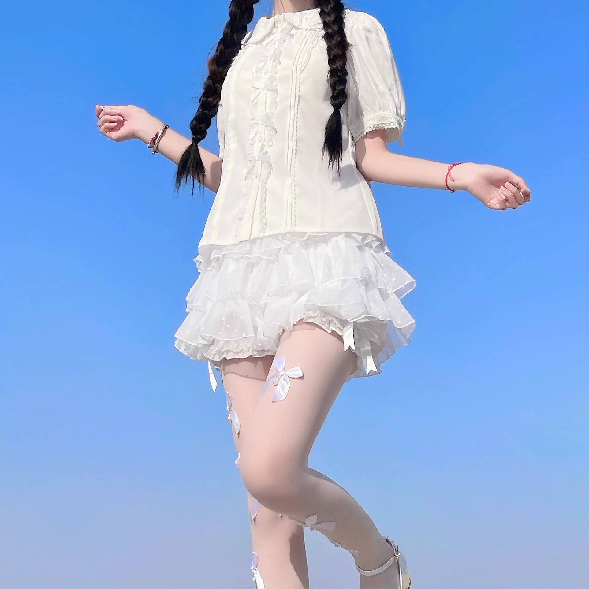 Inspired by moonlit summer nights, this delicate blouse features a classic Peter Pan collar and soft short sleeves. Crafted in pure white, its lightweight fabric and sweet design offer effortless versatility for daily wear. The subtle elegance captures a dreamy, youthful charm, perfect for pairing with summer skirts or jumpers. This piece embodies romantic simplicity, blending timeless Lolita aesthetics with modern comfort for enchanting warm-weather coordinations.