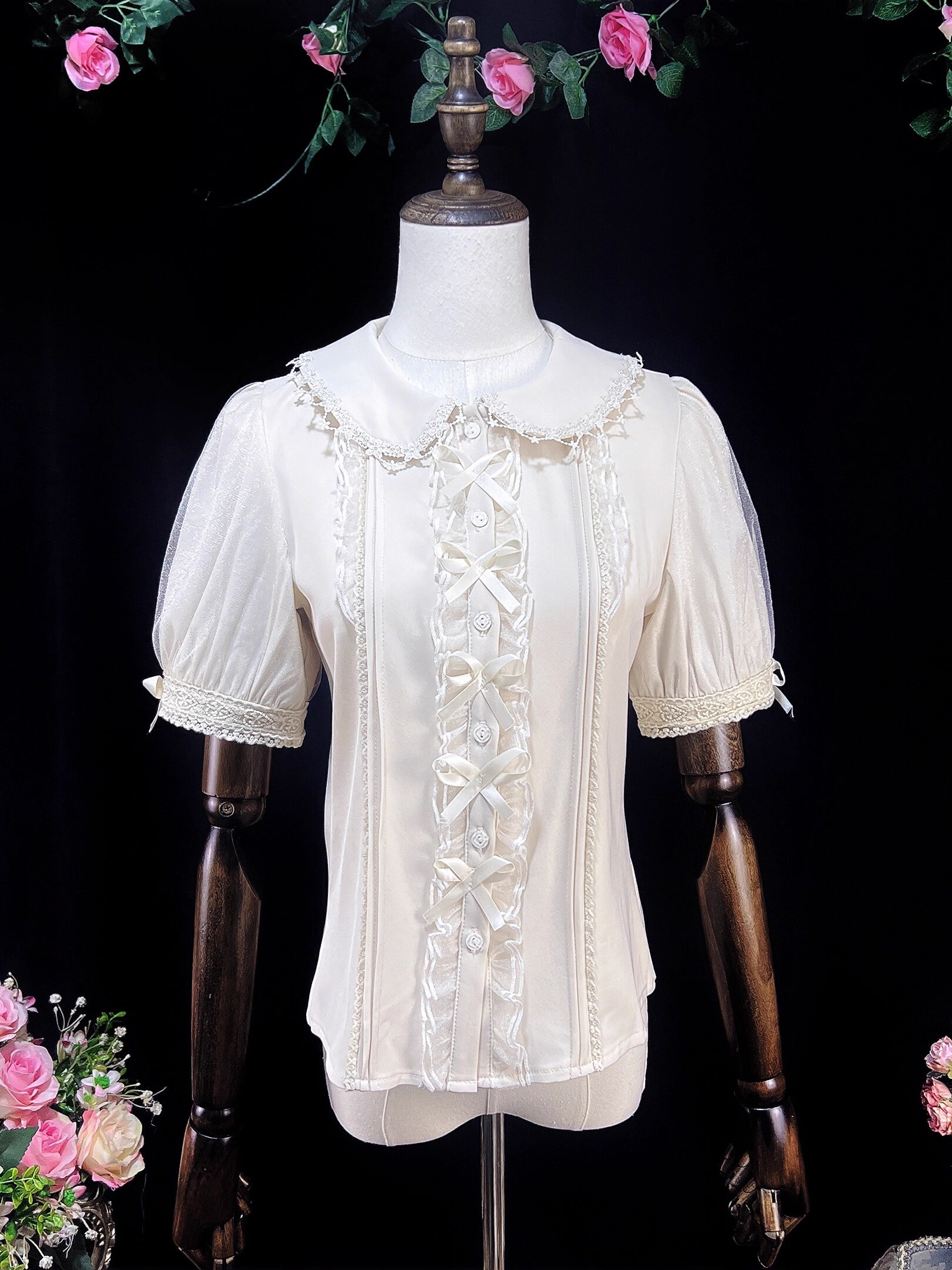 Inspired by moonlit summer nights, this delicate blouse features a classic Peter Pan collar and soft short sleeves. Crafted in pure white, its lightweight fabric and sweet design offer effortless versatility for daily wear. The subtle elegance captures a dreamy, youthful charm, perfect for pairing with summer skirts or jumpers. This piece embodies romantic simplicity, blending timeless Lolita aesthetics with modern comfort for enchanting warm-weather coordinations.