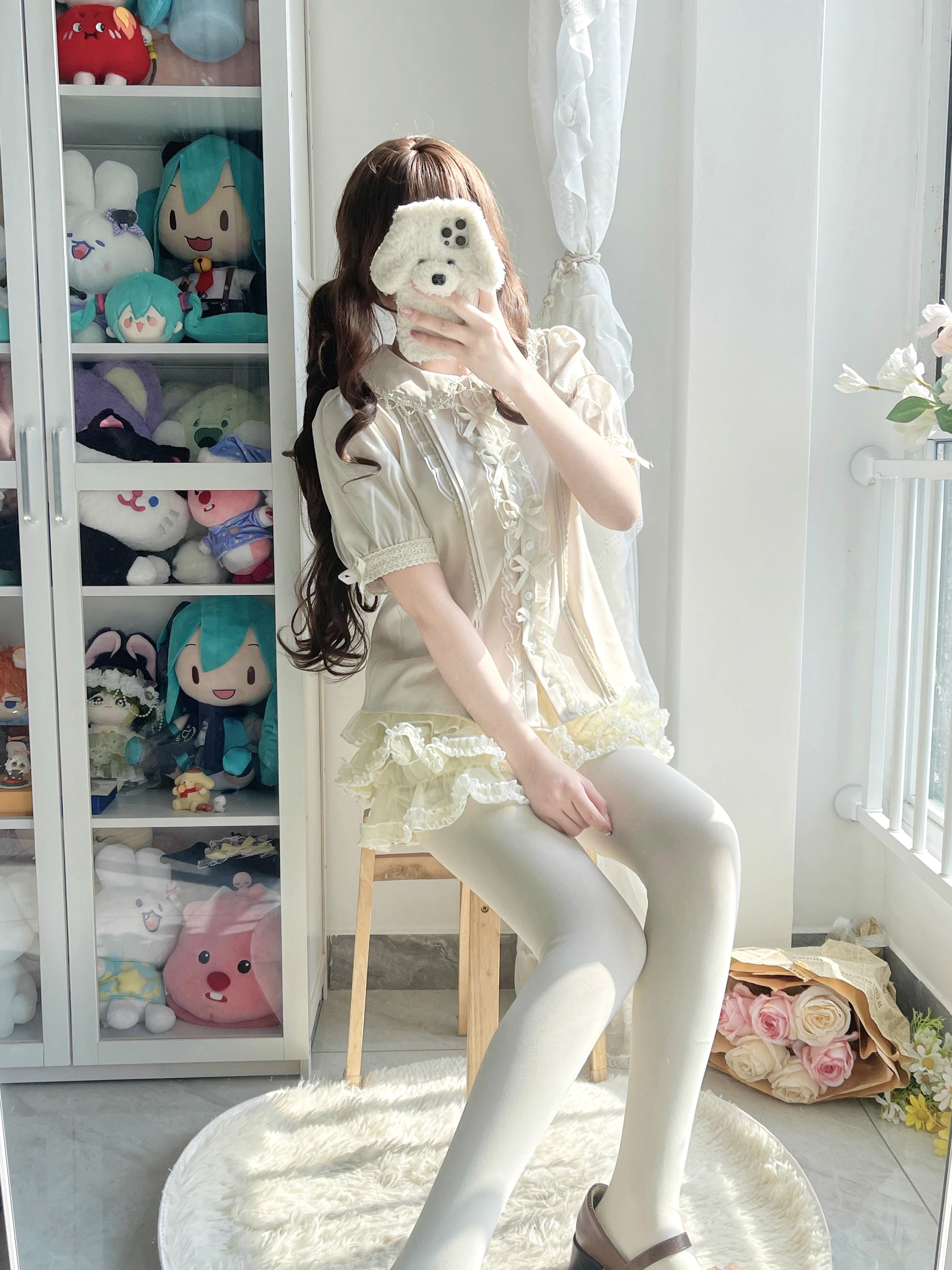 Inspired by moonlit summer nights, this delicate blouse features a classic Peter Pan collar and soft short sleeves. Crafted in pure white, its lightweight fabric and sweet design offer effortless versatility for daily wear. The subtle elegance captures a dreamy, youthful charm, perfect for pairing with summer skirts or jumpers. This piece embodies romantic simplicity, blending timeless Lolita aesthetics with modern comfort for enchanting warm-weather coordinations.