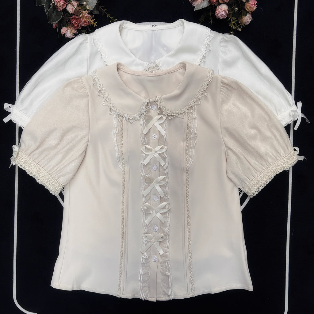 Inspired by moonlit summer nights, this delicate blouse features a classic Peter Pan collar and soft short sleeves. Crafted in pure white, its lightweight fabric and sweet design offer effortless versatility for daily wear. The subtle elegance captures a dreamy, youthful charm, perfect for pairing with summer skirts or jumpers. This piece embodies romantic simplicity, blending timeless Lolita aesthetics with modern comfort for enchanting warm-weather coordinations.
