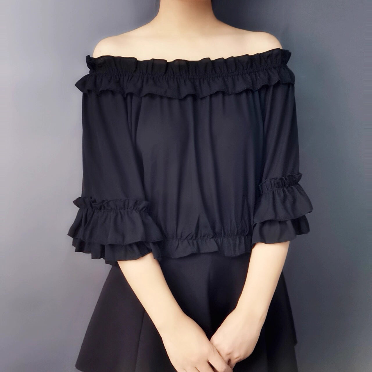 Design Concept:
This Lolita blouse captures a playful yet elegant summer aesthetic with its off-shoulder square neckline and delicate ruffle trims. The short-sleeve, loose-fit design ensures both comfort and style, making it an essential layering piece for Lolita wardrobes. Available in White and Black, it offers versatile choices for sweet or Gothic-inspired looks.