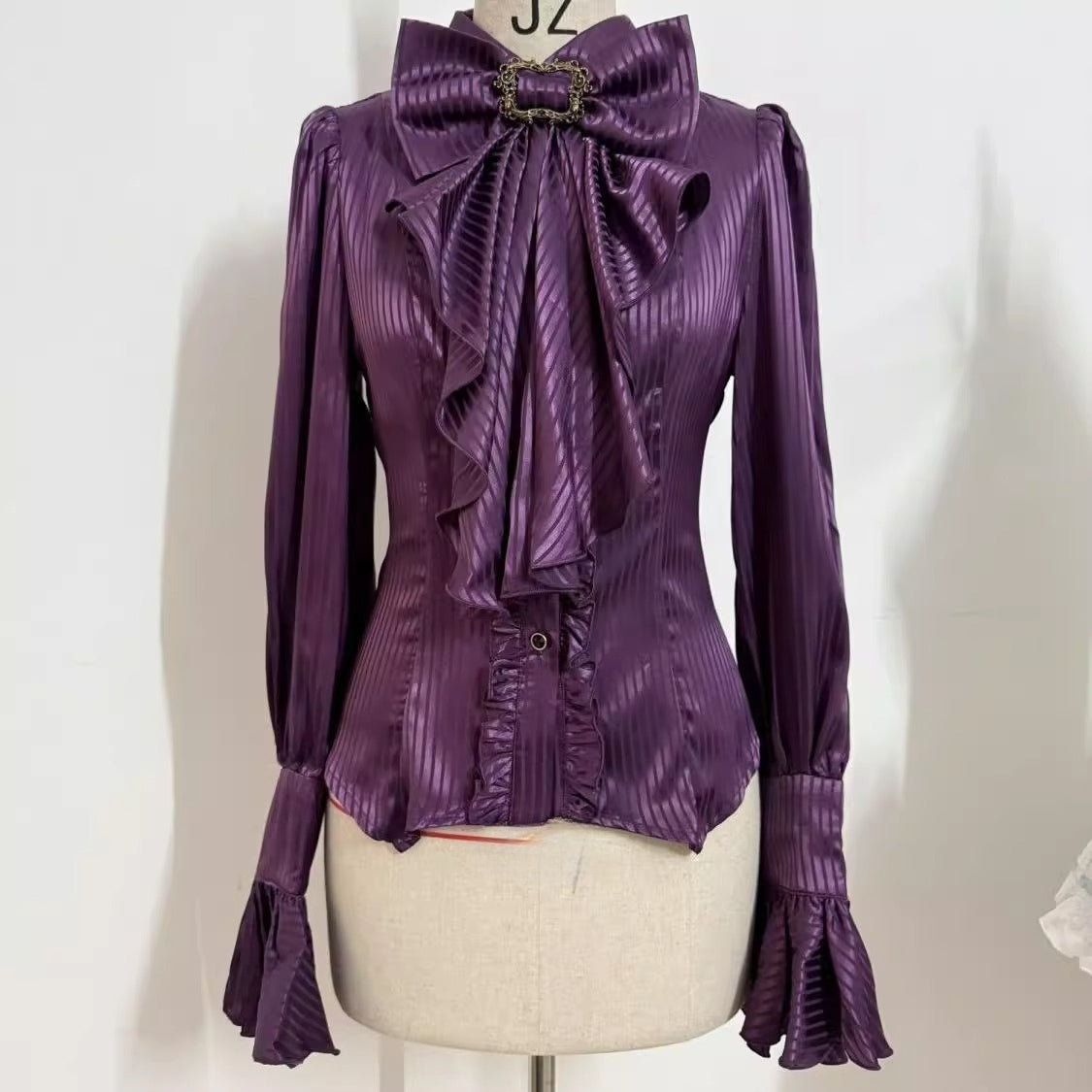 Design Concept:

This Lolita blouse in purple, white, and black blends Gothic charm with French vintage elegance. Designed with delicate tailoring and long sleeves, it creates a dramatic yet refined silhouette that is perfect for layering under Lolita dresses or wearing as a statement piece on its own. The versatile design makes it suitable for tea parties, cosplay events, and vintage-inspired gatherings, while the soft fabric ensures both comfort and style.