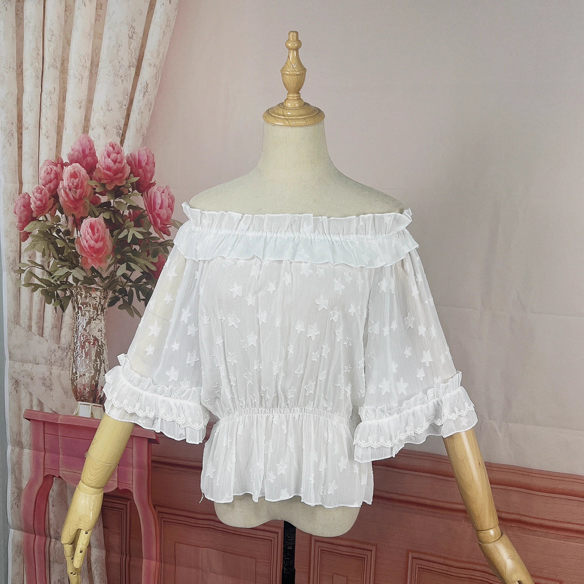 Delve into dreamy elegance with this Lolita chiffon blouse. Delicate prints adorn the lightweight, sheer fabric, while the elastic neckline offers a comfortable yet chic fit. Designed as a crop top, it pairs perfectly with JSK dresses, adding a layer of ethereal charm. The short sleeves and breathable material make it ideal for summer wear. Embrace a blend of whimsy and sophistication, perfect for creating a captivating Lolita ensemble that’s both graceful and stylish.