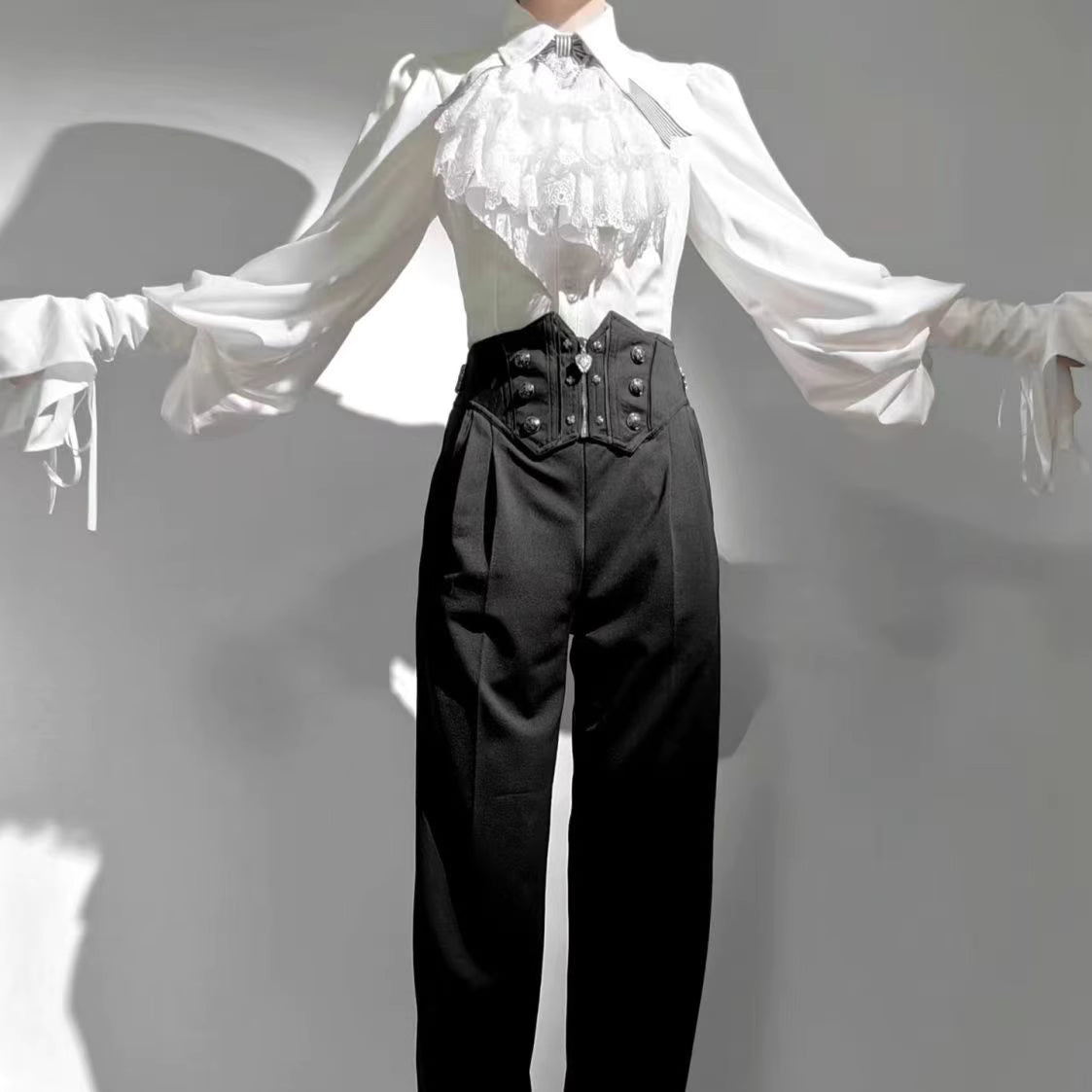Design Concept:

This Lolita blouse is a charming blend of vintage and medieval aesthetics, designed as a prince-style long-sleeve shirt perfect for layering or cosplay. Crafted in classic white and black, it features meticulous detailing that highlights the timeless elegance of Lolita fashion. The blouse offers a comfortable loose fit while maintaining a structured silhouette, making it ideal for daily wear, themed events, or tea parties. Pair it with skirts or trousers for a refined, versatile look that e