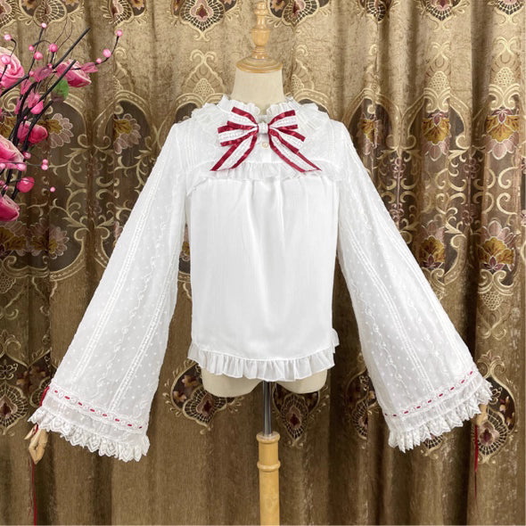This elegant blouse masterfully blends Victorian romance with subtle Chinese-inspired aesthetics. The dramatic double-layer bishop sleeves and delicate drawstring details create a luxurious, poetic silhouette. Topped with a classic bow tie, it offers a timeless look. Designed for the modern Lolita enthusiast, this undershirt is crafted from premium materials for both comfort and sophistication, making it the perfect foundational piece for creating a statement layered outfit that is both graceful and uniquel