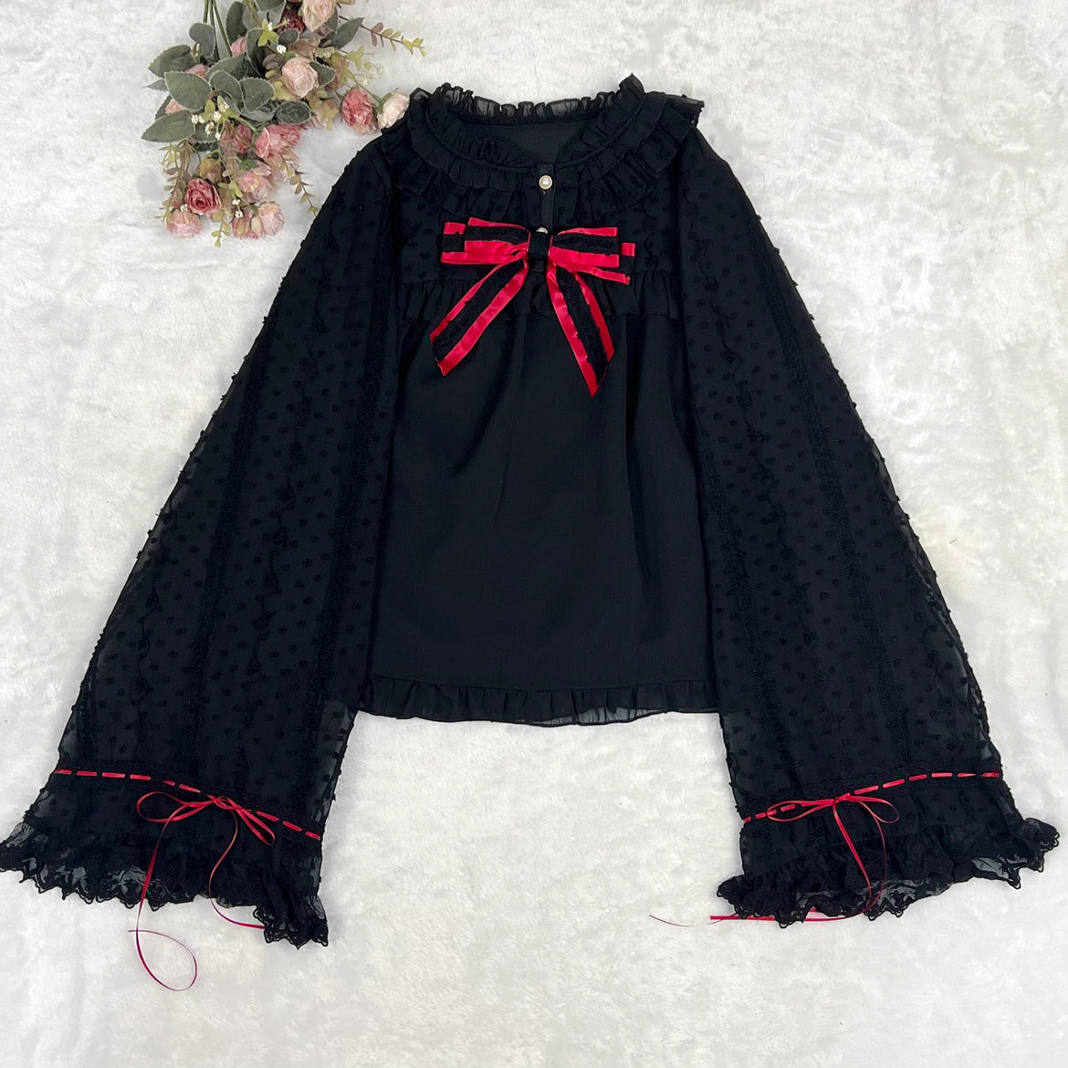 This elegant blouse masterfully blends Victorian romance with subtle Chinese-inspired aesthetics. The dramatic double-layer bishop sleeves and delicate drawstring details create a luxurious, poetic silhouette. Topped with a classic bow tie, it offers a timeless look. Designed for the modern Lolita enthusiast, this undershirt is crafted from premium materials for both comfort and sophistication, making it the perfect foundational piece for creating a statement layered outfit that is both graceful and uniquel