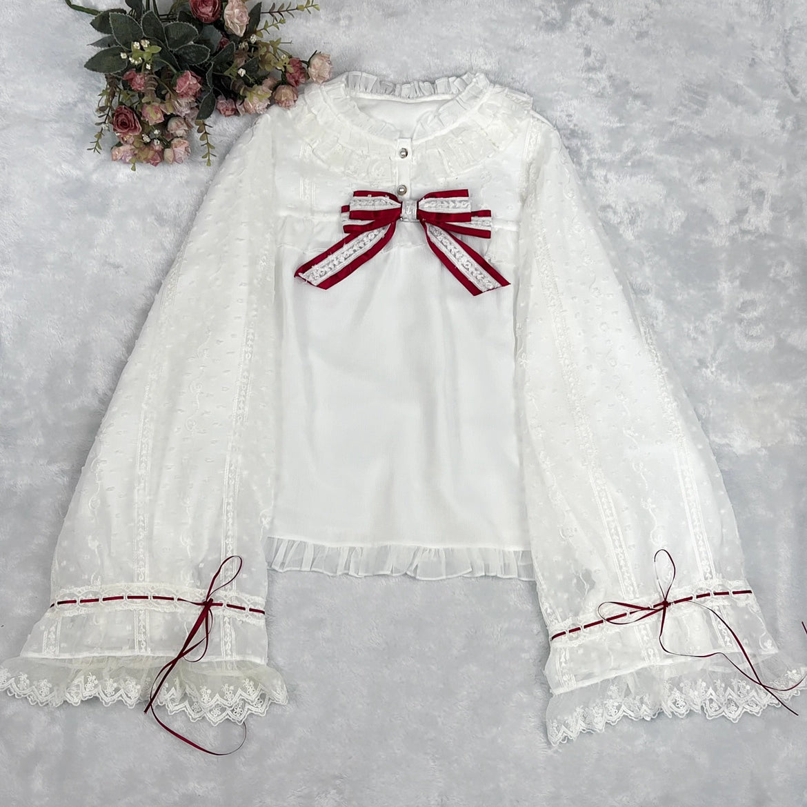 This elegant blouse masterfully blends Victorian romance with subtle Chinese-inspired aesthetics. The dramatic double-layer bishop sleeves and delicate drawstring details create a luxurious, poetic silhouette. Topped with a classic bow tie, it offers a timeless look. Designed for the modern Lolita enthusiast, this undershirt is crafted from premium materials for both comfort and sophistication, making it the perfect foundational piece for creating a statement layered outfit that is both graceful and uniquel