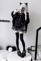 Blending whimsy with elegance, this cape coat transforms classic Lolita charm into a versatile outerwear piece. The playful rabbit ears and delicate bow contrast the monochrome palette, creating a striking balance between sweetness and sophistication. Designed with a flowing silhouette and single-row button closure, it offers effortless layering for cool days—perfect for adding a touch of fantasy to both casual and formal Lolita coordinates.
