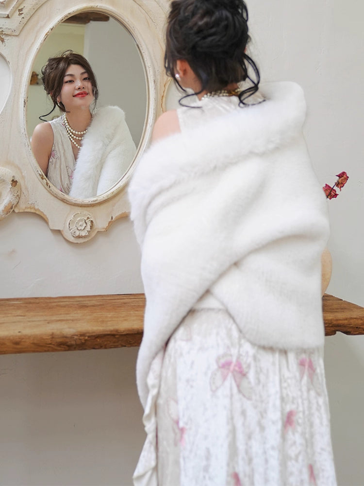 Inspired by the ethereal texture of cloud mousse, this wrap embodies luxurious comfort. Crafted from incredibly soft, plush faux mink fur, it offers a guilt-free, vegan-friendly opulence. The pure white hue and elegant shawl collar design evoke timeless French elegance. Lightweight yet cozy, it's the perfect statement piece for effortless style and sublime warmth, blending ethical fashion with a touch of romantic sophistication.