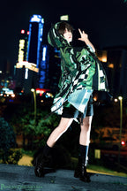 This coat merges Lolita’s classic silhouette with cyberpunk’s dystopian edge. Structured shoulders and a tailored waist contrast with tactical harness details and glitch-art graphic prints. Crafted from heavy-duty wool blend, it features metallic hardware and neon accent stitching, blending Victorian elegance with futuristic rebellion. Designed for commanding presence in both digital and urban landscapes, it embodies a fusion of dark romance and tech-driven defiance.