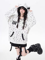 A light grey open-front cardigan blending subtle sweetness with streetwise softness. Delicate cross-stitch embroidery and a small kitten motif create a quiet yet charming statement, while the relaxed hooded design offers effortless layering potential. Perfect for early autumn's in-between weather—soft, lightweight, and subtly expressive.