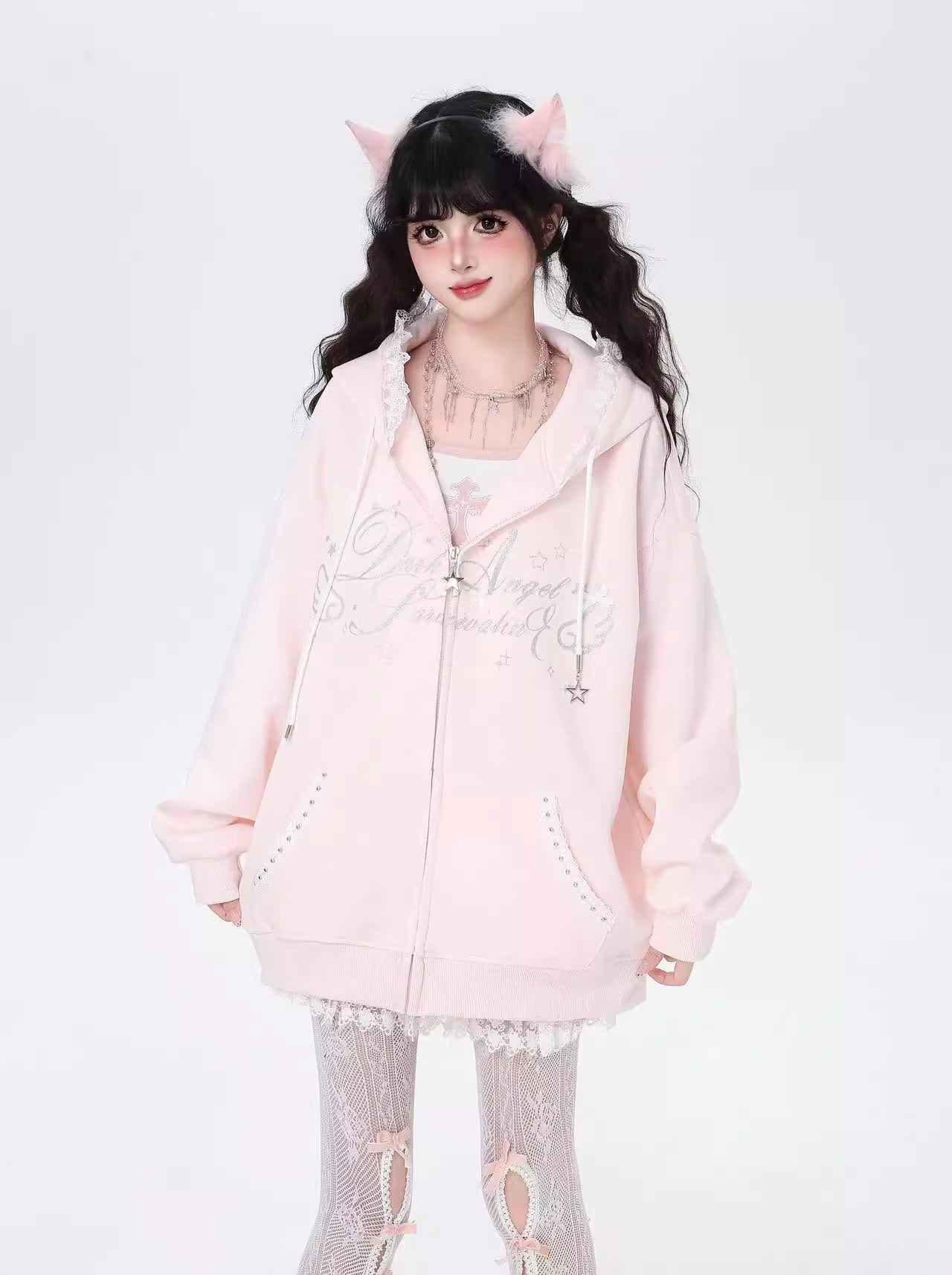Blending streetwear ease with delicate charm, this hoodie features soft lace accents and a relaxed oversized fit. The playful pink, black, and blue color-blocking adds youthful energy, while the cozy fabric ensures comfort. Perfect for layering, it subtly merges softness with urban casual style.