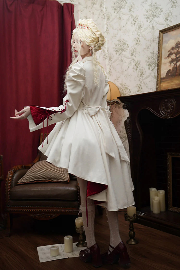 This coat defies convention with its dramatic asymmetrical hemline, blending Gothic mystery and Lolita elegance. The stark white hue and sharp double-breasted structure create a striking visual tension, while the elongated back silhouette adds a touch of theatrical romance. Designed for those who dare to stand out, it transforms the wearer into a vision of haunting beauty—where darkness and light intertwine in poetic contrast.